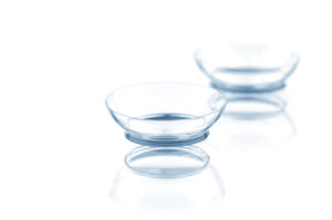 Two contact lenses with reflections, isolated on a white background